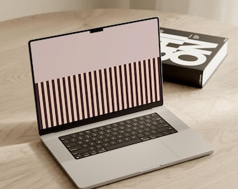 May include: A silver laptop with a black keyboard and a screen displaying a graphic pattern of a solid light pink upper section and a lower section featuring vertical dark brown and light pink stripes. The text NEUTRAL CONCEPT is visible.