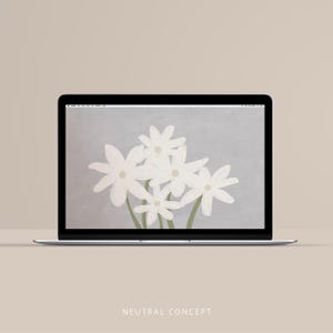 May include: A laptop displaying a floral wallpaper with white flowers on a gray background. The laptop is on a beige surface. The text "NEUTRAL CONCEPT" is at the bottom of the screen.
