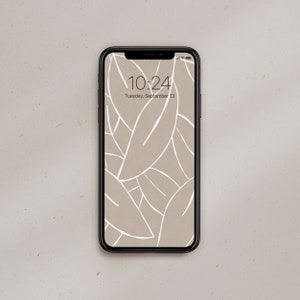 May include: A black smartphone with a white leaf pattern wallpaper. The time is 10:24 and the date is Tuesday, September 13.