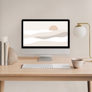 May include: A modern desktop workspace with a computer monitor displaying a minimalist abstract landscape wallpaper. The monitor is on a light wood desk with a white keyboard, a white mouse pad, a white coffee mug, and a small rock sculpture.