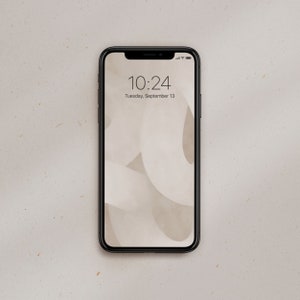 May include: A black smartphone with a white background on the screen. The time is 10:24 and the date is Tuesday, September 13.