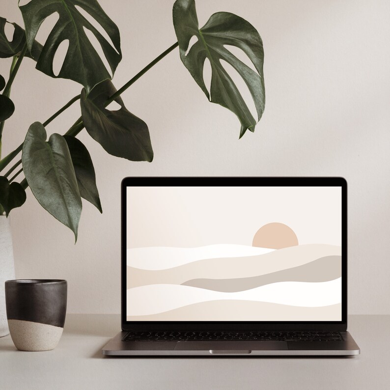 May include: A laptop computer with a minimalist abstract landscape wallpaper on the screen. The wallpaper features a light brown sun and beige and gray waves on a white background. A potted green plant is in the background.
