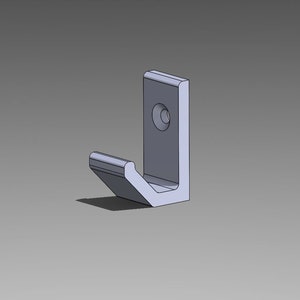 May include: A silver metal hook with a single hole for mounting. The hook is designed to be mounted on a wall or other surface.