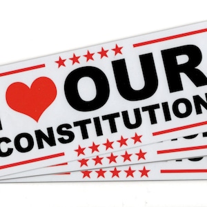 May include: Three white stickers with red and black text. The top sticker says "I ♥ OUR CONSTITUTION" with red stars above and below the text. The stickers are stacked on top of each other.