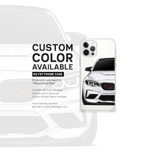 May include: A white phone case featuring a black and white illustration of a BMW M2 F87. The case is clear and offers a custom colour option. The text "CUSTOM COLOR AVAILABLE" and "M2 F87 PHONE CASE" is printed on the case.