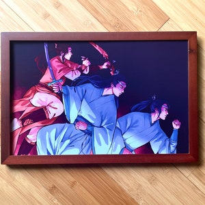 May include: A framed print of a fantasy illustration featuring three figures in a dark setting. The figures are dressed in blue and red clothing and appear to be engaged in a fight. The print is framed in a dark wood frame.