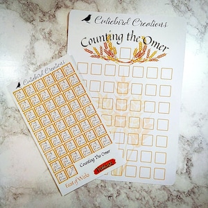 May include: A set of stickers for counting the Omer, a Jewish tradition. The stickers are in the shape of squares with a gold border and feature the text "Day of Omer" and a number from 1 to 49. The stickers are arranged in a grid pattern on a white background. The image also includes a printable chart with a wheat design and the text "Counting the Omer".
