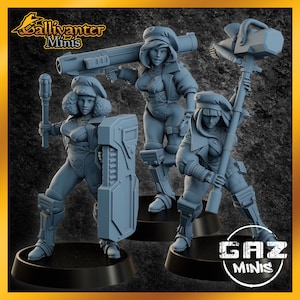 May include: Three gray miniature figurines of female characters in futuristic attire, each holding a weapon. One figure carries a rocket launcher, another a shield, and the third a large hammer. The figurines are on black bases, with the text "Gallivanter Minis" and "GAZ MINIS" visible.