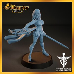 A figurine of a female character with a sword, standing on a platform and holding a shield.