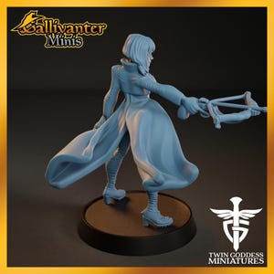 A figurine of a woman with flowing hair and a flowing dress, holding a weapon, is displayed on a platform.