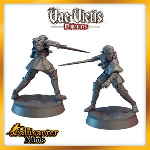 May include: Two gray painted miniature figures of elves holding swords. The figures are posed in a dynamic fighting stance. The figures are on round bases.