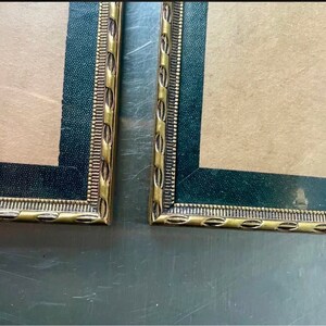 Pair of Identical Gold colored metal frames each measures  14.5 cm X 9 cm CONVEX glass