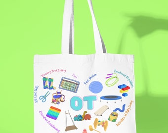 May include: White canvas tote bag with the word "OT" in blue and light blue letters surrounded by colorful illustrations of various activities and tools used in occupational therapy, including a wheelchair, scissors, a jump rope, a swing set, a puzzle, a ball, and a toy dinosaur.