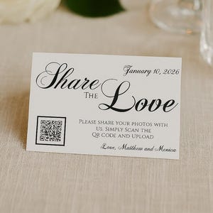 May include: A white card with the words "Share the Love" in elegant script, along with the date "January 10, 2026." It includes a QR code and instructions to share photos. The card is signed "Love, Matthew and Monica."
