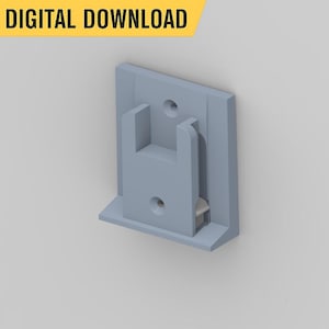 May include: A light gray plastic wall mount bracket with a rectangular shape and a small lip on the bottom. The bracket has two holes for screws.