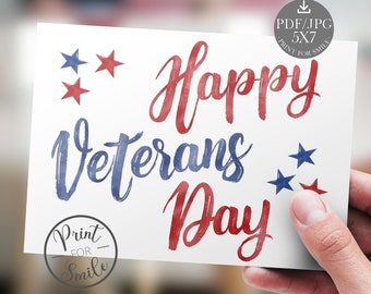 May include: A white card with the words "Happy Veterans Day" in red and blue watercolor lettering. The card features red and blue stars and a "Print for Smile" logo.