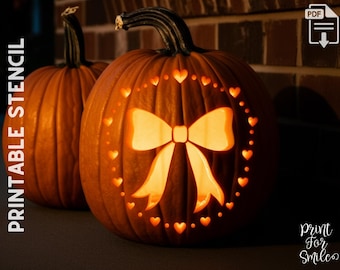 May include: Two orange pumpkins, one with a carved bow and heart design, illuminated from within. The pumpkins are set against a dark background, with the words "PRINTABLE STENCIL" visible on the left side.