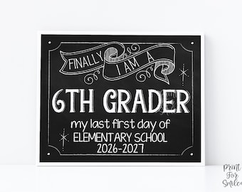May include: A black chalkboard sign with white hand-lettered text that reads FINALLY I AM A 6TH GRADER, my last first day of ELEMENTARY SCHOOL, and 2026-2027. The design features a decorative banner at the top and star accents on the sides.