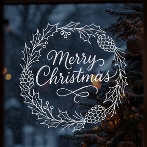 May include: White Christmas window art with the words "Merry Christmas" in elegant script, surrounded by a wreath of holly leaves and pinecones. The printable art measures approximately 22x22 inches.