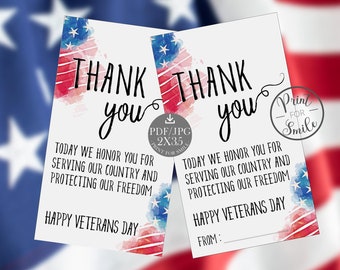 May include: Two white Veterans Day thank you cards with red, white, and blue watercolor accents. The cards read "THANK YOU" and "Today we honor you for serving our country and protecting our freedom." The cards are formatted for 8 tags per US Letter page.