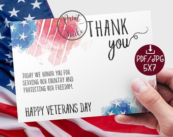 Op de afbeelding: Een witte kaart van 5x7 inch met aquarelaccenten van de Amerikaanse vlag. De kaart leest "Thank you" in zwart schrift, met de zinnen "Today we honor you for serving our country and protecting our freedom" en "Happy Veterans Day."