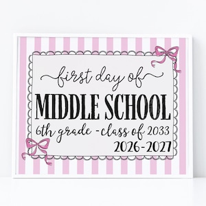 May include: A rectangular sign with a light pink and white vertical striped border. The center features a white background with a scalloped black frame, pink bows, and the text: first day of MIDDLE SCHOOL 6th grade - class of 2033 2026-2027.