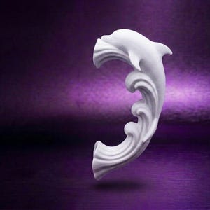 May include: A white, curved decorative element featuring a sculpted dolphin at the top, transitioning into stylized, flowing wave patterns that extend downward in a C-shape. The object has a smooth, matte finish and a solid, uniform white color.
