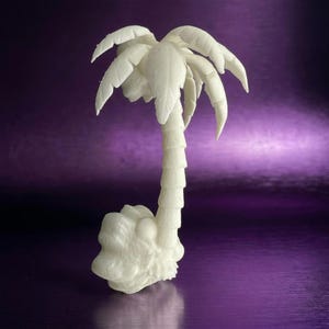 May include: A white, three-dimensional palm tree figurine featuring a textured, segmented trunk and detailed, drooping fronds at the top. The base of the tree is rounded and textured, providing a stable foundation for the upright structure.