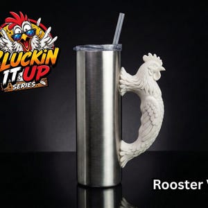 May include: A stainless steel tumbler with a clear lid and straw, featuring a white, textured rooster-shaped handle. The graphic logo above the tumbler displays a cartoon chicken wearing sunglasses with the text CLUCKIN IT UP SERIES.