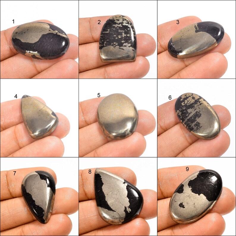 May include: Nine cabochon cut pyrite gemstones, each with a unique shape and size. The stones are a mix of black and gold with a metallic sheen.