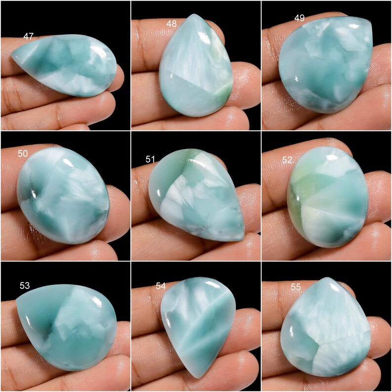 May include: Ten cabochon gemstones, each with a unique pattern of blue and white, are displayed on a hand. The gemstones are labeled with numbers 47 through 55.