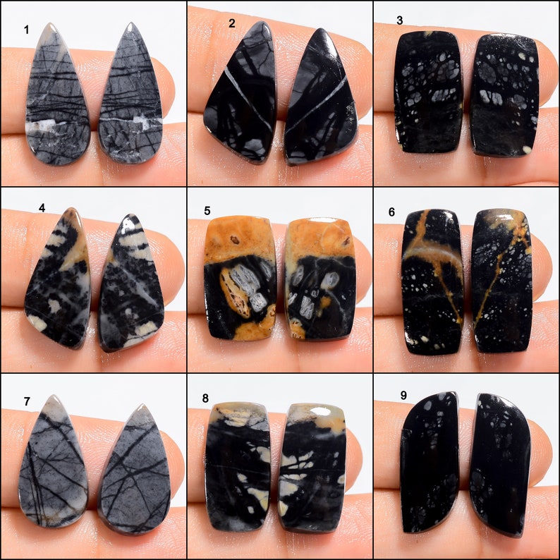 May include: Nine pairs of black and white gemstone cabochons, each pair is a different shape and pattern. The cabochons are arranged in a grid of three rows and three columns.