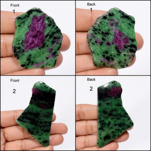 May include: Two green, black, and pink zoisite rough stones. The stones are irregular in shape and have a mottled appearance. The stones are labelled "Front" and "Back" with numbers 1 and 2.
