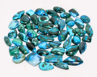 May include: A collection of polished gemstones in shades of blue and green. The stones vary in shape, including oval, rectangular, and irregular forms. The gemstones have a marbled appearance with swirling patterns.