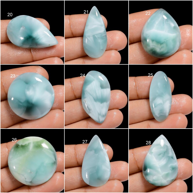 May include: Nine different cabochon gemstones, each with a unique pattern of blue, green, and white. The gemstones are all oval or teardrop shaped and are arranged in a grid.