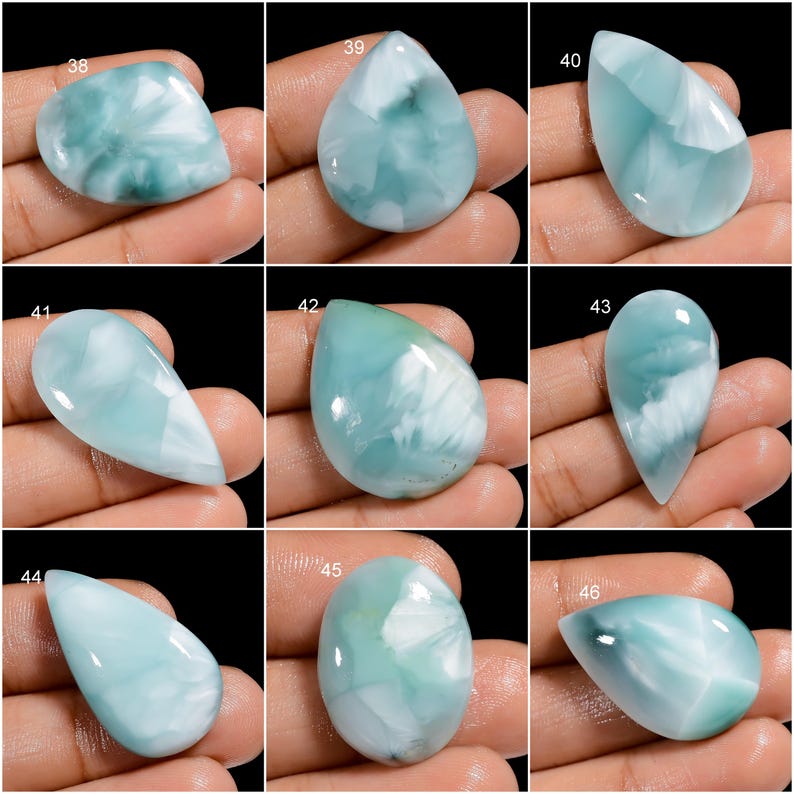 May include: Nine cabochon gemstones, each with a unique pattern of white and blue, are displayed on a hand. The gemstones are labeled with numbers 38 through 46.