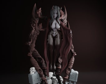 May include: A detailed figurine of a female figure with long, dark hair and a flowing red robe. She is standing on a base with skulls and skeletal structures.