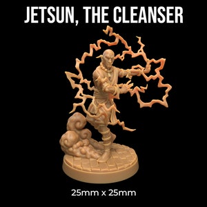 May include: A miniature figurine of a bald, light brown-skinned man wearing a light brown robe and holding a glowing orange lightning bolt. The figurine is standing on a circular base with a textured surface. The text "Jetsun, The Cleanser" is at the top of the image. The base is 25mm x 25mm.