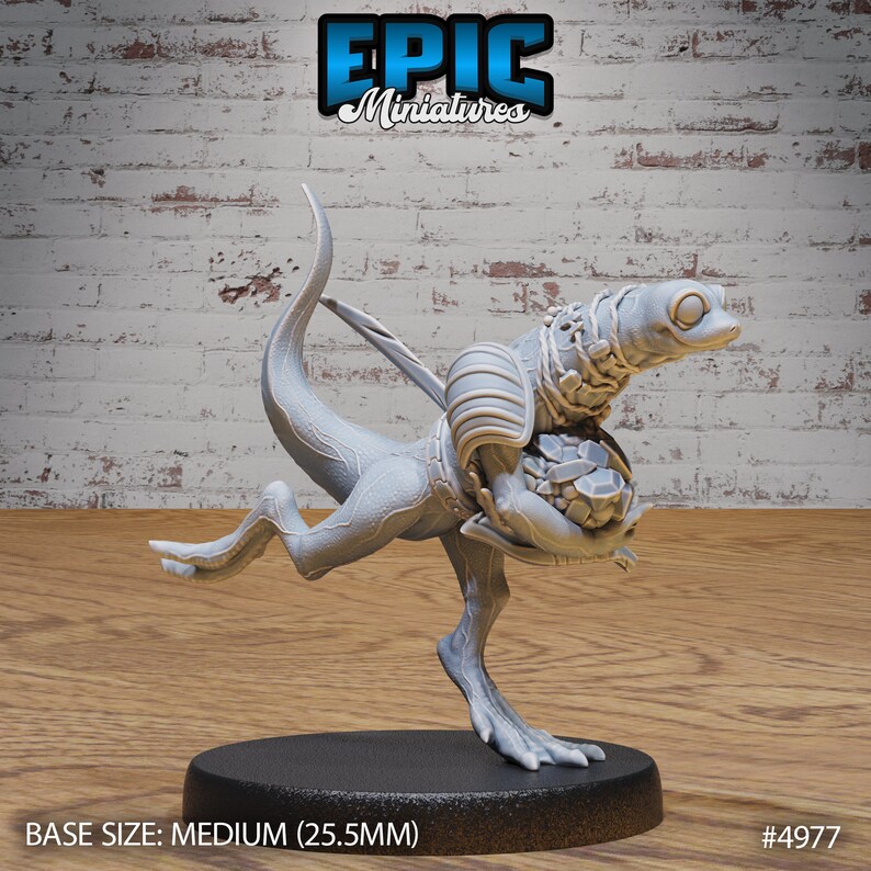 May include: A gray 3D printed miniature of a lizard-like creature with a large head and a bag of gems in its hands. The miniature is standing on a round base. BASE SIZE: MEDIUM (25.5MM) #4977