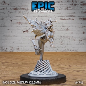 May include: A gray 3D printed miniature of a fairy with wings, wearing a dress and standing on a round base. The base is decorated with a spiral pattern. The miniature is 25.5 mm in size. #4745