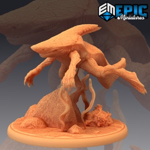 May include: A detailed, orange-toned miniature of a fantastical creature, possibly a hybrid of a shark and a turtle. The figure has textured skin, outstretched limbs, and is posed on a rocky base with aquatic plants. The base is round.