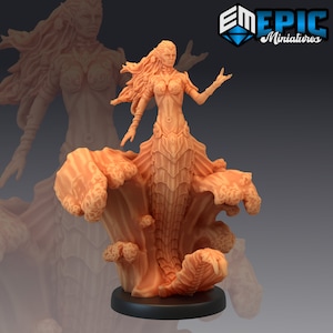 May include: A detailed miniature figurine of a mermaid with a scaly tail and a flowing, sculpted dress. The mermaid is standing on a base with a sculpted wave design. The figurine is painted in a light orange color.