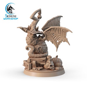 May include: A brown, sculpted figurine of a cat wearing a witch's hat and holding a bell. The cat has bat wings and is sitting on a stack of books with a skull and pumpkins beside it.