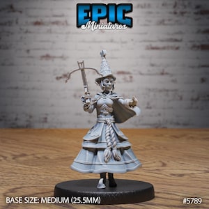 May include: A grey miniature figure of a female character with a crossbow, wearing a hat and dress. The figure is on a black base. The text "EPIC Miniatures" is at the top. The base size is medium (25.5mm).