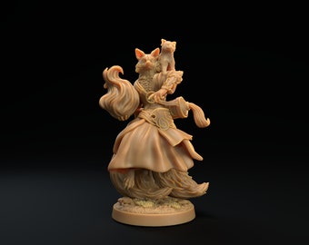 May include: A painted figurine of a fox-like creature wearing a robe and holding a staff. The creature has a fluffy tail and is standing on a base. A small cat figurine is perched on the creature's shoulder.