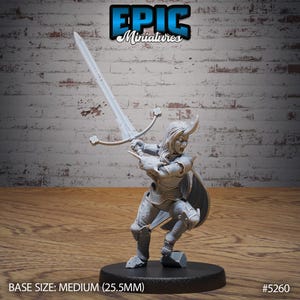 May include: A gray, unpainted miniature of a female warrior figure holding a sword. The figure is wearing armor and has a horned helmet. The miniature is standing on a round base. BASE SIZE: MEDIUM (25.5MM) #5260