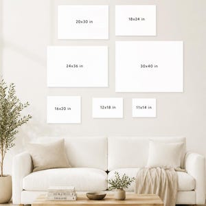 May include: A living room scene featuring a white sofa, wooden coffee table, and various decorative elements. Seven blank white canvases of different sizes are displayed on the wall, with dimensions in inches: 11x14, 12x18, 16x20, 18x24, 20x30, 24x36, and 30x40.