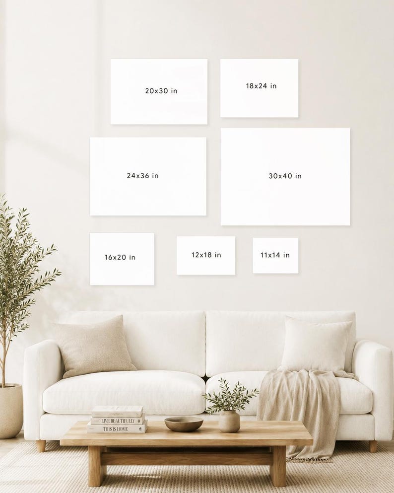 May include: A living room scene featuring a white sofa, wooden coffee table, and various decorative elements. Seven blank white canvases of different sizes are displayed on the wall, with dimensions in inches: 11x14, 12x18, 16x20, 18x24, 20x30, 24x36, and 30x40.