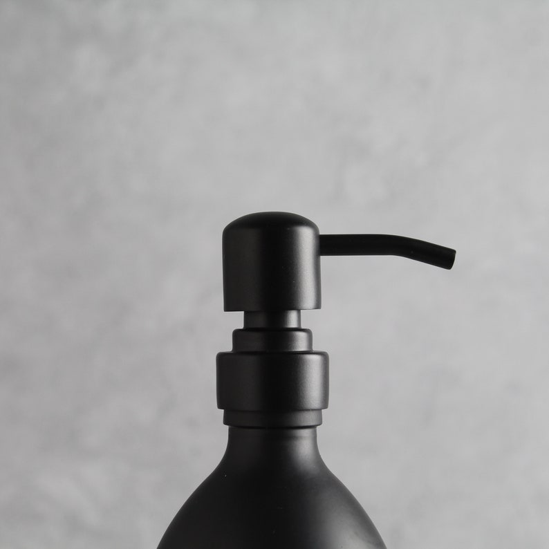 May include: A black soap dispenser with a pump top and a sleek, modern design.