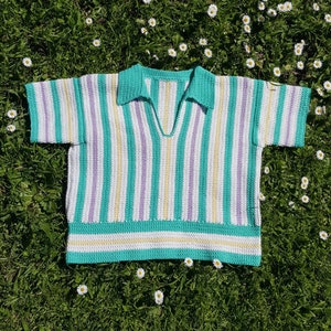 Puede incluir: Un top de punto de crochet a rayas con cuello en V y mangas cortas. El top est&aacute; hecho en una variedad de colores, incluyendo verde, blanco, morado y amarillo.
